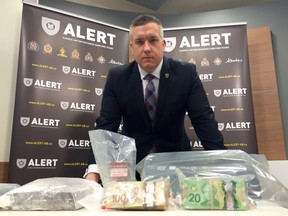RCMP Staff Sgt. Dave Knibbs RCMP Staff Sgt. Dave Knibbs poses with some of the cocaine and money seized following the Alberta Law Enforcement Response Teams arrest of a Hells Angels member in Edmonton.