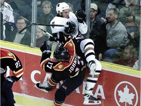 Tom Poti, seen here in action in October 2001, was booed by Oiler fans after a contract holdout. Poti has advice for Justin Schultz, now the subject of fans' ire.