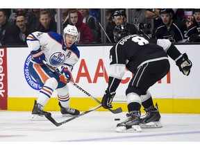 Edmonton Oilers left wing Taylor Hall (4) looks for the the open man as he tries to get past Los Angeles Kings defenseman Drew Doughty (8) during the first period of an NHL hockey game, Thursday, Feb. 25, 2016, in Los Angeles.