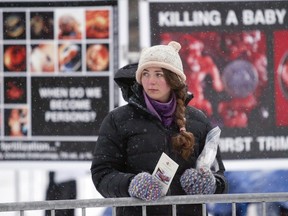 A Pro-Life student hands out pamphlets at the University of Calgary in 2009. A U of A club planning a similar event this week in Edmonton says it faced a $17,500 security fee. File photo.