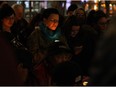 Robin Eaglewhistleblower holds a candle surrounded by supporters at a vigil for missing and murdered indigenous women at Churchill Square in Edmonton on Wednesday, Feb. 10, 2016.