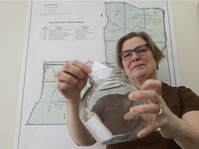 City of Edmonton returning officer Laura Kennedy poses Friday with the jar that will be used to draw the name of the winning Ward 12 candidate if there is a tie Monday in the byelection.