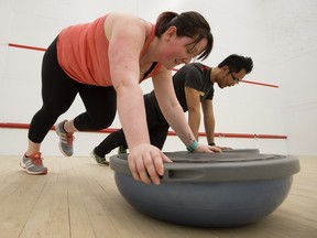 Becky Parak works out with personal fitness trainer Genghis Barranda at the Jamie Platz YMCA, at 7121 178 St. The pair use Fitbits during their workouts.