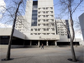 A pedestrian walks past the front entrance to the old Edmonton Remand Centre, 9660 - 104 Ave.