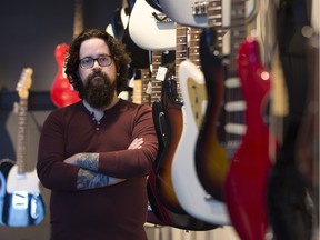 Stang Guitars manager Rory Brown stands in front of some instruments at the store. On March 25, 2016, thieves smashed the store's front door and stole 16 guitars valued at over $27,000.