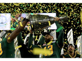 WINNIPEG, CANADA - NOVEMBER 29:  Mike Reilly #13 of the Edmonton Eskimos holds the Grey Cup after the team defeated the Ottawa Redblacks at Investors Group Field during Grey Cup 103 on November 29, 2015 in Winnipeg, Manitoba, Canada.