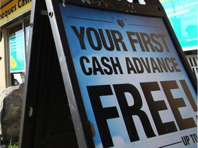 Mike Brown, public policy coordinator with Momentum, a non-profit that teaches financial literacy to low income earners, outside a payday loans service on 16th Avenue NW Friday September 25, 2015.