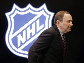 NHL commissioner Gary Bettman walks onto the stage for a news conference before the NHL hockey All-Star game skills competition Saturday, Jan. 30, 2016, in Nashville, Tenn. The NHL won't comment on an NFL executive's recent acknowledgment the brain disease CTE can be linked to football because it's not "necessary or appropriate" and the two sports are different, hockey's commissioner said Wednesday. THE CANADIAN PRESS/AP/Mark Humphrey