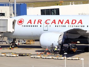 In this July 28, 2011 file photo, an Air Canada plane sits at a gate at the Sydney Airport in Sydney, Australia.