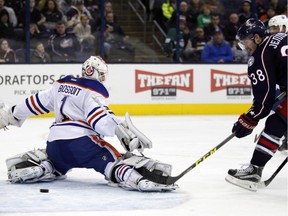 Columbus Blue Jackets' Boone Jenner, right, scores past Edmonton Oilers goalie Laurent Brossoit during the second period of an NHL hockey game in Columbus, Ohio, Friday, March 4, 2016.