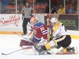 Brandon Wheat Kings centre Reid Duke collides with the net during a rush towards Edmonton Oil Kings goaltender Payton Lee during Game 2 of their WHL playoff series at Westman Place in Brandon, Man., on March 25, 2016.