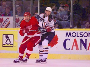 Bryan Marchment tangles with a Red Wings player duriing his days as an Oiler.