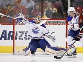 Edmonton Oilers' Cam Talbot, left, makes a save on a shot by Arizona Coyotes' Jiri Sekac, of the Czech Republic, as Oilers' Mark Fayne (5) defends during the first period of an NHL hockey game, Tuesday, March 22, 2016, in Glendale, Ariz.