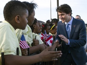 Canadian Prime Minister Justin Trudeau greets students from D.C.'s Patterson Elementary School after he arrived wiht his family at Andrews Air Force Base, Md., on March 9, 2016, in advance of a state dinner with U.S. President Barack Obama.