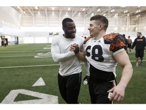 Alex Ogbongbemiga, left, and DJ Lalama celebrate their selection to advance to the CFL's national combine in Toronto.
