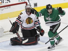 Dallas Stars center Tyler Seguin (91) celebrates a goal from teammate Jason Spezza (not shown) as Chicago Blackhawks goalie Corey Crawford, left, looks on during the first period of an NHL hockey game Friday, March 11, 2016, in Dallas.