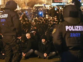 Police officers in riot gear block far-right supporters and hooligans stopped in the street of the Connewitz district in Leipzig, Germany, on Jan. 11, 2016, as extremists went on a rampage on the sidelines of a xenophobic rally.