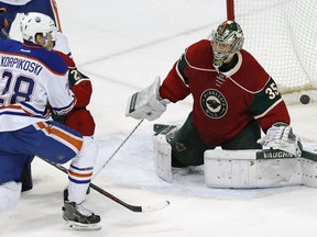 Edmonton Oilers' Lauri Korpikoski, left, of Finland, scores a power play goal on Minnesota Wild goalie Darcy Kuemper in the first period of an NHL hockey game Thursday, March 10, 2016, in St. Paul, Minn.