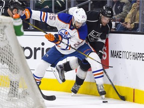 Edmonton Oilers defenseman Darnell Nurse (25) and Los Angeles Kings center Andy Andreoff (15) vie for possession of the puck during the second period of an NHL hockey game, Thursday, Feb. 25, 2016, in Los Angeles.