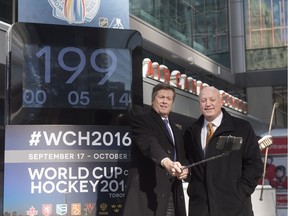Toronto Mayor John Tory, left, and NHL Deputy Commissioner Bill Daly pose for a selfie as they unveil the tournament countdown clock for the World Cup of Hockey 2016 in Toronto on Wednesday, March 2, 2016.