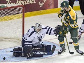 University of Alberta Golden Bears' Brett Ferguson is stopped by St. Francis Xavier goalie Drew Owsley during CIS championship hockey action in Halifax on March 17, 2016.