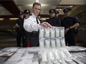 Edmonton Police Service Insp. Ed McIsaac and downtown beat officers pose Thursday, March 31, 2016, following a seizure of $96.000 in street drugs.