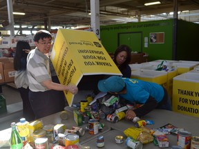 Workers unload a food box at Toronto's Daily Bread Food Bank.