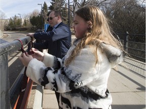 Alyx Walker,11, and Arnold Ferri tie neckties Thursday on the High Level Bridge in a symbolic gesture as the Canadian Association for Equality calls on the federal government in their national campaign to expand the proposed inquiry into missing and murdered Indigenous women and girls to include boys and men.