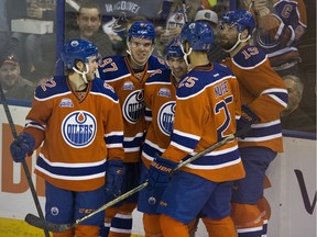 Edmonton Oilers forward Jordan Eberle celebrates his goal against the Vancouver Canucks with teammates during second period NHL action on March 18, 2016 in Edmonton.
