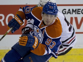 Edmonton Oilers  Ryan Nugent-Hopkins (93) is chased by Chicago Blackhawks Marko Dano (56) during first period NHL action on November 18, 2015, in Edmonton.  (Greg Southam-Edmonton Journal)