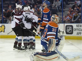 Cam Talbot and Darnell Nurse of the Edmonton Oilers, watch the Colorado Avalanche celebrate their second goal at Rexall Place in Edmonton on Feb. 20, 2016.