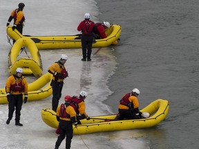 EDMONTON, AB.--  Firefighters participate in their annual swift water ice trainingas they enter the North Saskatchewan River, carried downstream and then rescued lysing specialized crafts. They will also perform self-rescues from the water onto ice shelves. These exercises showcase the specialized training and equipment used in ice rescue operations. Taken on March 3, 2016, in Edmonton. (Greg Southam)