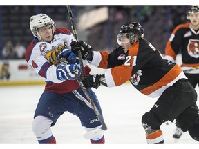 EDMONTON, AB. JANUARY 25, 2014 - Garan Magnes of the Edmonton Oil Kings, gets cross checked by Chad Butcher of the Medicine Hat Tigers at Rexall Place in Edmonton. Shaughn Butts/Edmonton Journal