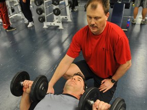 File photo: When choosing a personal trainer, finding a coach that cares can be more important to productive workouts than picking someone with technical knowledge.