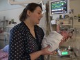 Jessica Pott holds her son Henry in the Stollery Children's Hospital neonatal intensive care unit . Parents can now stay with their babies overnight thanks to a newly established Family Care Unit.