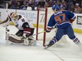Arizona goalie Mike Smith makes a save on Edmonton's Connor McDavid during the Coyotes’ 4-0 win over the Oilers March 12, 2016, at Rexall Place.