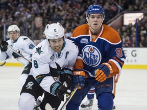 Connor McDavid of the Edmonton Oilers, right, and Joe Pavelski of the San Jose Sharks look for the puck in the corner at Rexall Place in Edmonton on March 8, 2016.