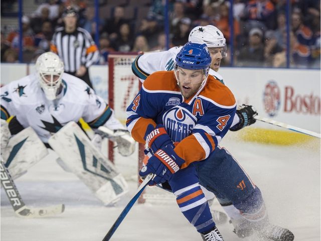 Taylor Hall of the Edmonton Oilers, steers away from Joe Pavelski of the San Jose Sharks at Rexall Place in Edmonton. 