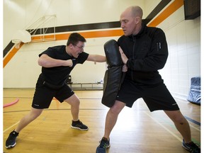 Maxwell Metselaar, 16, and Const. Bruce McGregor take part in the Edmonton Police Service's 2016 Youth Recruit Academy on Thursday, March 31, 2016, at McNally High School in Edmonton.