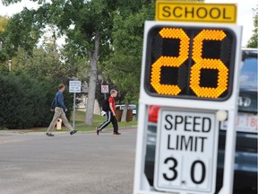 Electronic signs clocked speeds in the 30 km/h school zone near Westglen School in September 2014.