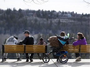 Families enjoy the warm weather, and river valley view, on March 27, 2016.