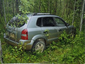 This evidence photo from the Travis Vader murder trial shows the SUV belonging to Lyle and Marie McCann that was found in the woods after their disappearance.