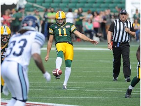 EDMONTON, ALBERTA, AUGUST 23, 2014: grant Shaw punts in the first half during a game between the Edmonton Eskimos and Toronto Argonauts in Commonwealth Stadium in Edmonton on Saturday Aug. 23, 2014. Reilly suffered a jammed thumb on the play was was taken out of the game(photo by John Lucas/Edmonton Journal)(for a story by Chris O'Leary)