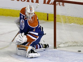 Edmonton Oilers goalie Laurent Brossoit watches the puck go into the net during first period NHL hockey game action against the Nashville Predators in Edmonton on Monday March 14, 2016.