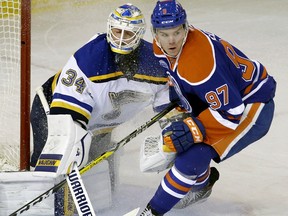 Edmonton Oilers centre Connor McDavid (right) skates past St. Louis Blues goalie Jake Allen during NHL action in Edmonton on March 16, 2016.