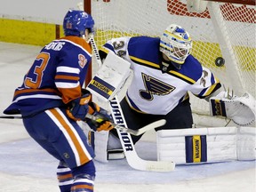 St. Louis Blues goalie Jake Allen (right) makes a save against Edmonton Oilers Ryan Nugent-Hopkins during second period NHL hockey game action in Edmonton on March 16, 2016.