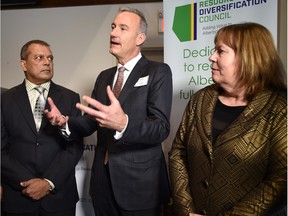 David Chappell with Williams Energy Canada talks to the media flanked by Energy Minister Marg McCuaig-Boyd and Naushad Jamani of NOVA Chemicals as Industry and labour leaders gathered to announce the creation of a new organization called the Resource Diversification Council in Edmonton, March 16, 2016.