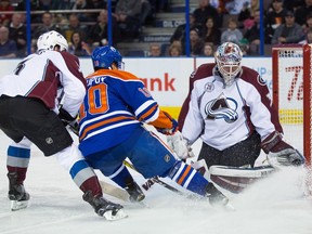 Nail Yakupov (10) of the Edmonton Oilers shot is blocked by goalie Calvin Pickard (31) of the Colorado Avalanche during second period action at Rexall Place in Edmonton on March 20, 2016.