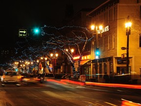 The streaks from passing cars provide a modern contrast to the familiar lights of the Strathcona Hotel, the oldest building in the Strathcona neighbourhood.