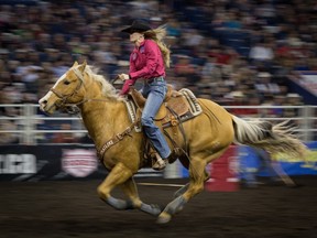 Aimee Kay competes in the ladies barrel race at the Canadian Finals Rodeo at Rexall Place in Edmonton on November 11, 2015.
